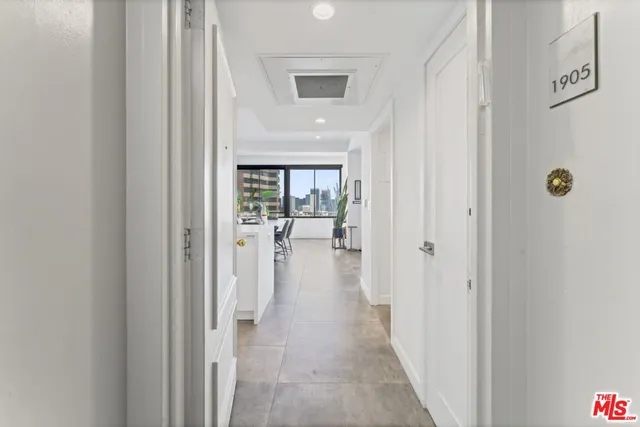 a view of a hallway with wooden floor windows and a livingroom view