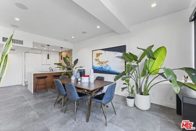 a view of a dining room with furniture and a potted plant
