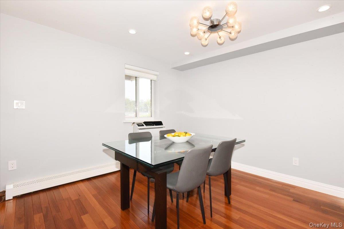320 East Shore Road, Unit 2A Great Neck, NY 11023 - Photo 15 of 28 a view of a dining room with furniture and wooden floor