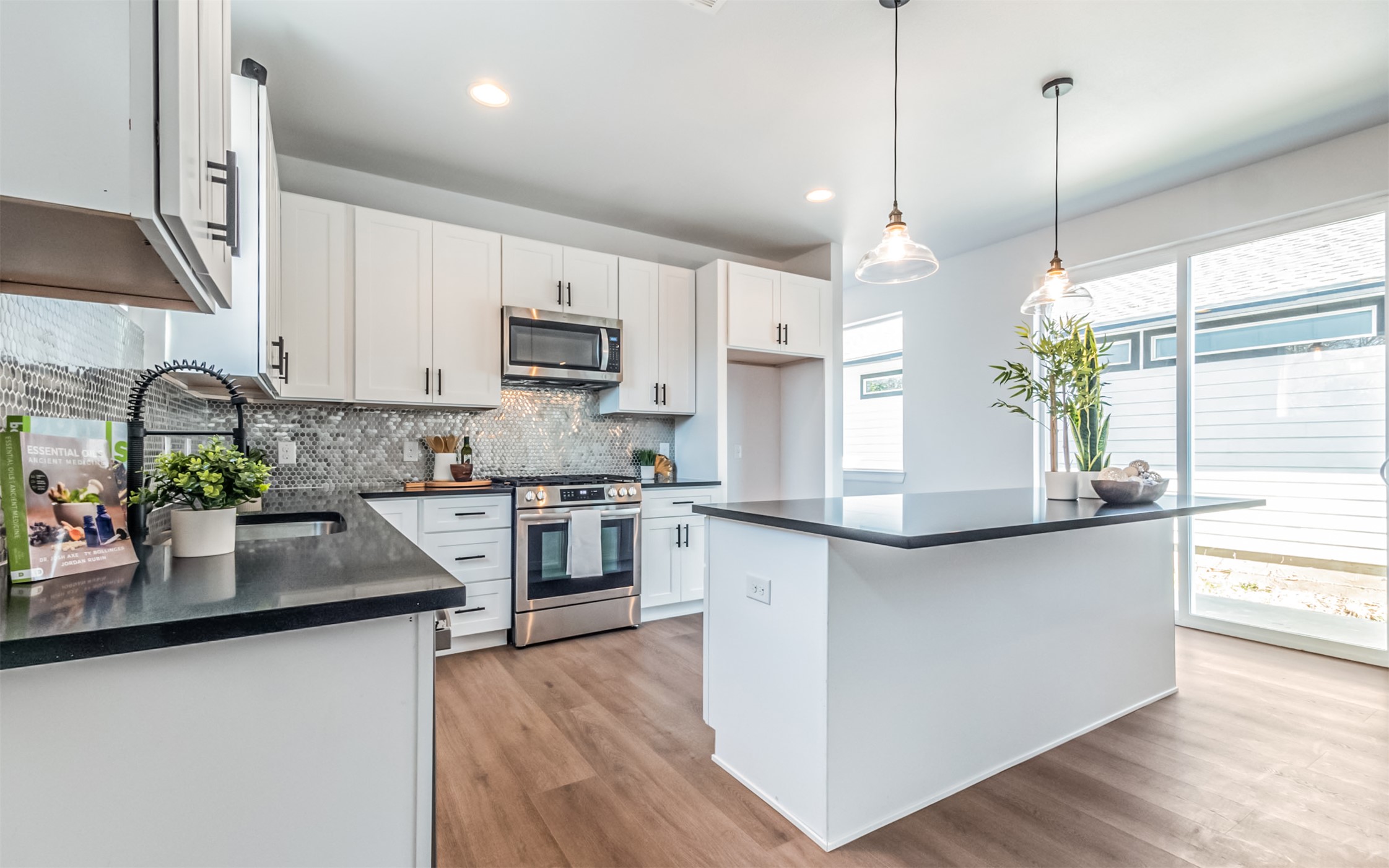 1130 Spur Street, Unit A Austin, TX 78721 - Photo 7 of 31 Kitchen featuring stainless steel appliances, pendant lighting, a center island and white cabinetry