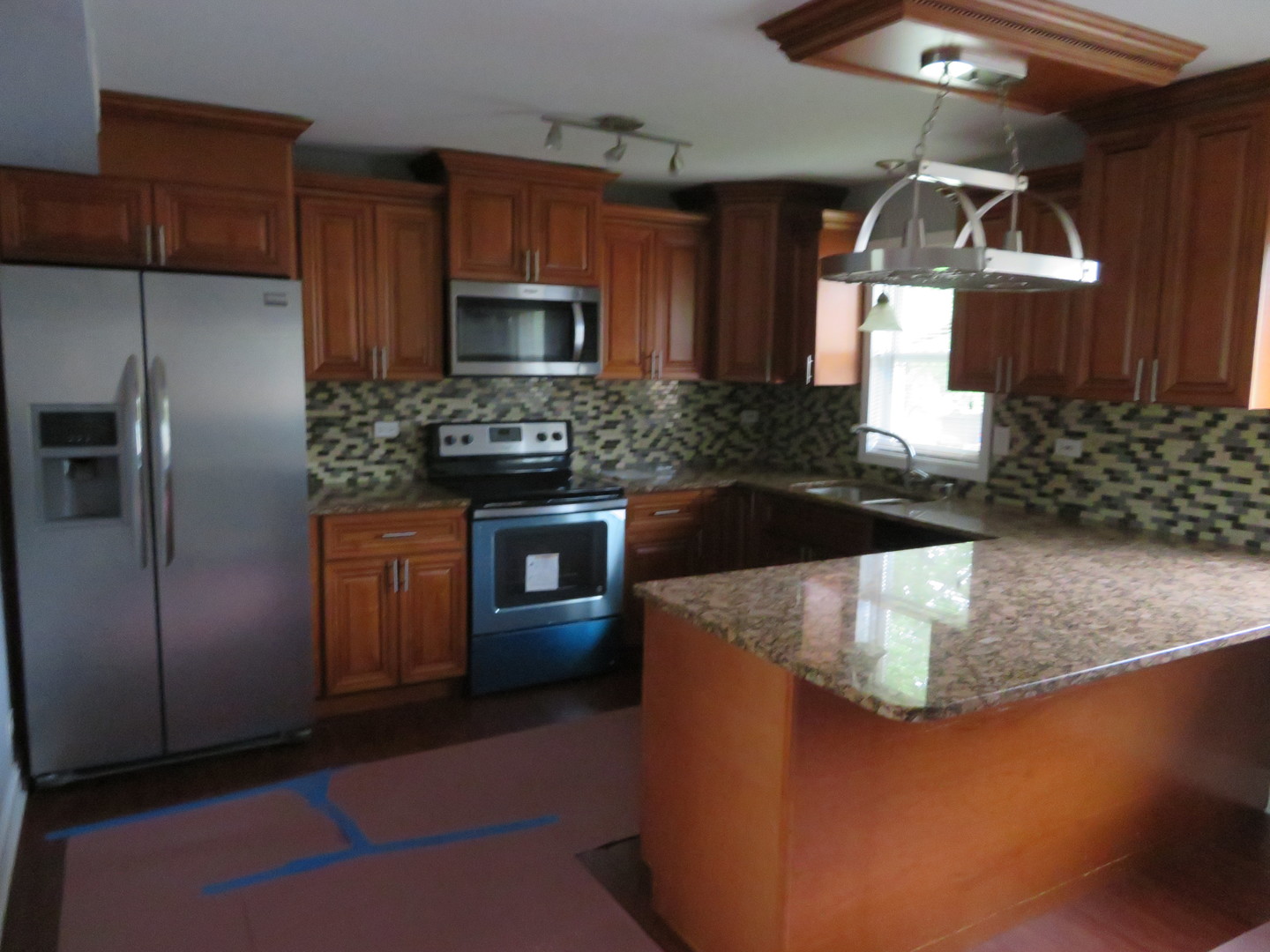 6834 West Lode Drive, Unit 3A Worth, IL 60482 - Photo 3 of 11 a kitchen with kitchen island granite countertop a sink stainless steel appliances and cabinets