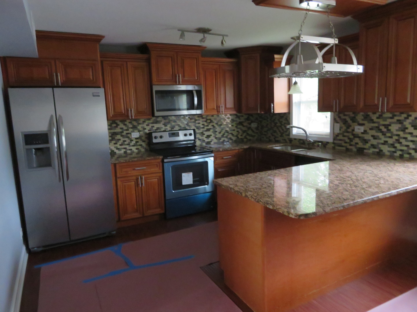 6834 West Lode Drive, Unit 3A Worth, IL 60482 - Photo 4 of 11 a kitchen with stainless steel appliances granite countertop a refrigerator a stove and a sink with wooden cabinets