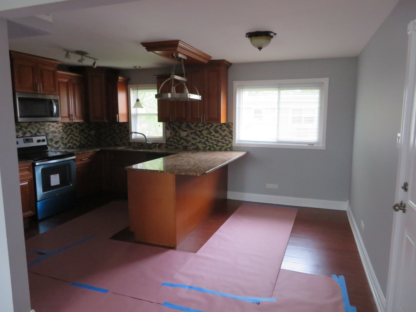 6834 West Lode Drive, Unit 3A Worth, IL 60482 - Photo 5 of 11 a kitchen with stainless steel appliances granite countertop a stove a sink and a refrigerator