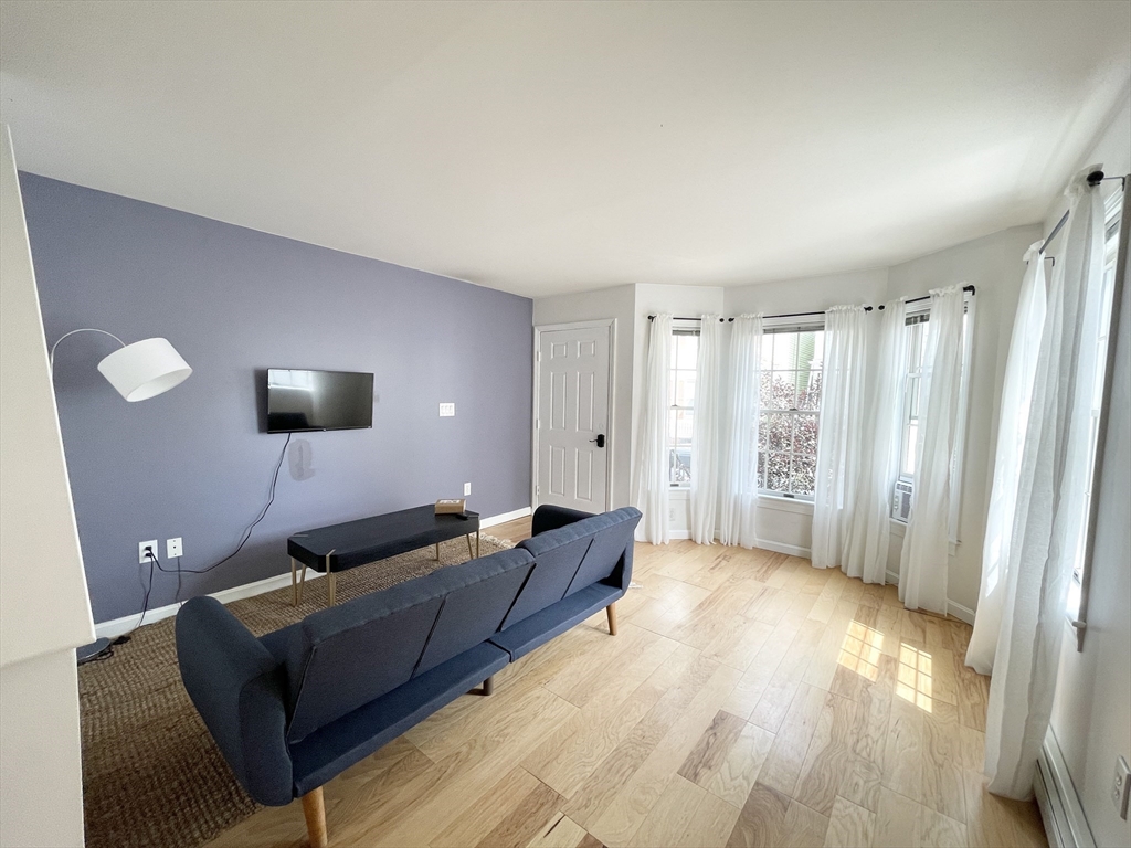 2 Holden Street, Unit 2 Boston, MA 02125 - Photo 4 of 12 a living room with furniture and a wooden floor