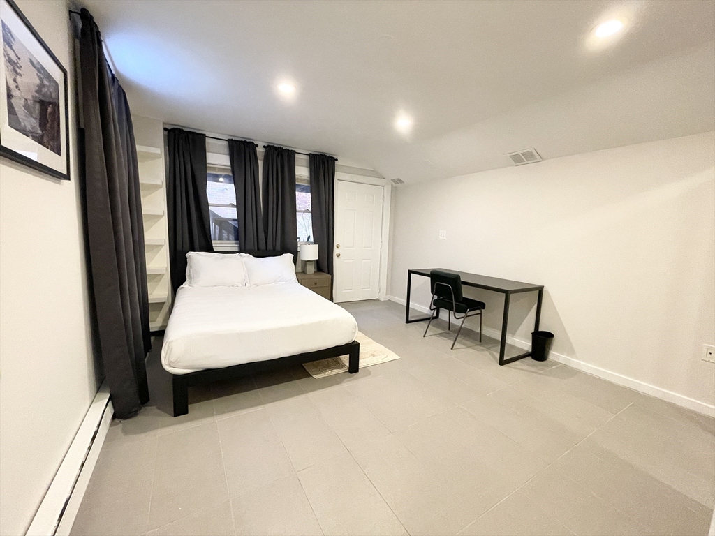 2 Holden Street, Unit 2 Boston, MA 02125 - Photo 7 of 12 a bedroom with a bed and a chair