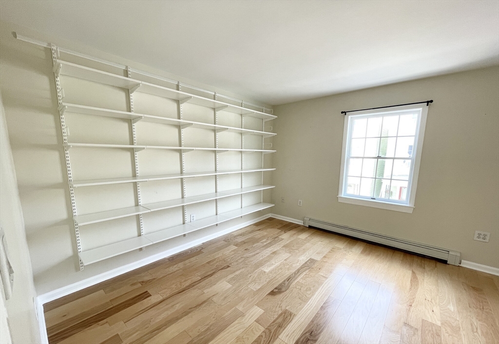 2 Holden Street, Unit 2 Boston, MA 02125 - Photo 8 of 12 a view of a room with wooden floor and cabinet