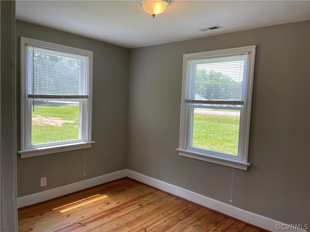 8243 Varina Road Henrico, VA 23231 - Photo 17 of 23 a view of an empty room with wooden floor and a window