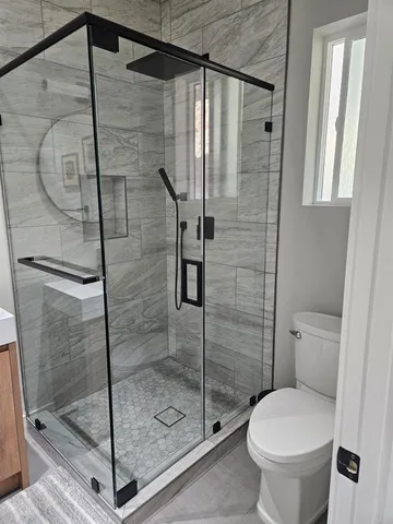 a bathroom with a shower and toilet