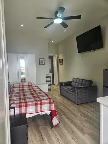 a bedroom with a bed and a flat screen tv