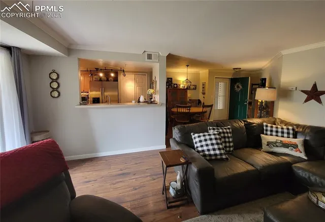 a view of empty room with furniture and wooden floor