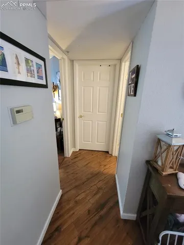 a bedroom with two beds and wooden floor