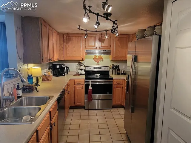 a kitchen with a sink cabinets and stainless steel appliances