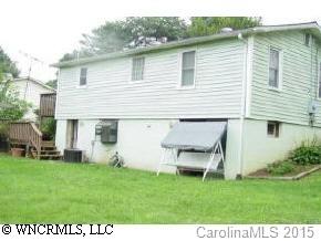 18 Smith Graveyard Road Asheville, NC 28806 - Photo 3 of 4 a view of a backyard with table and chairs and potted plants
