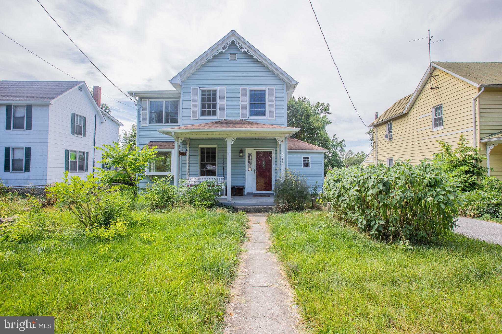 a front view of a house with a yard and porch