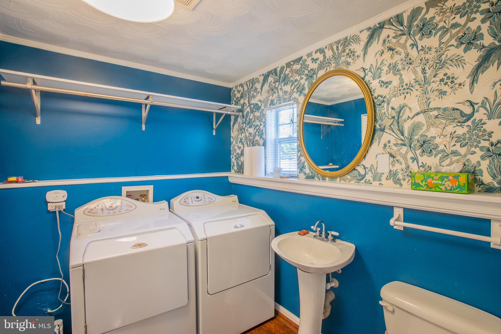 8875 Baltimore Street Savage, MD 20763 - Photo 14 of 32 a bathroom with a sink a toilet and a mirror