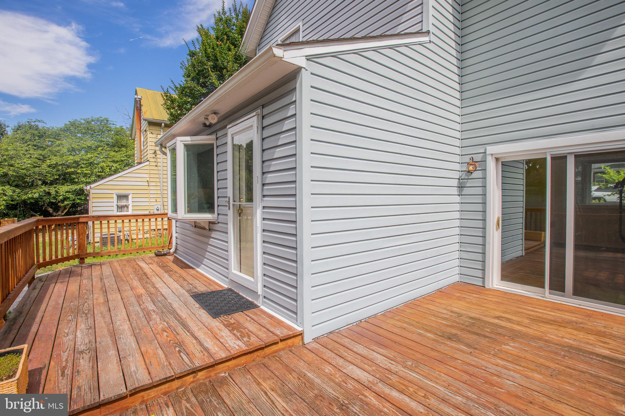 8875 Baltimore Street Savage, MD 20763 - Photo 16 of 32 a view of a wooden deck with a patio