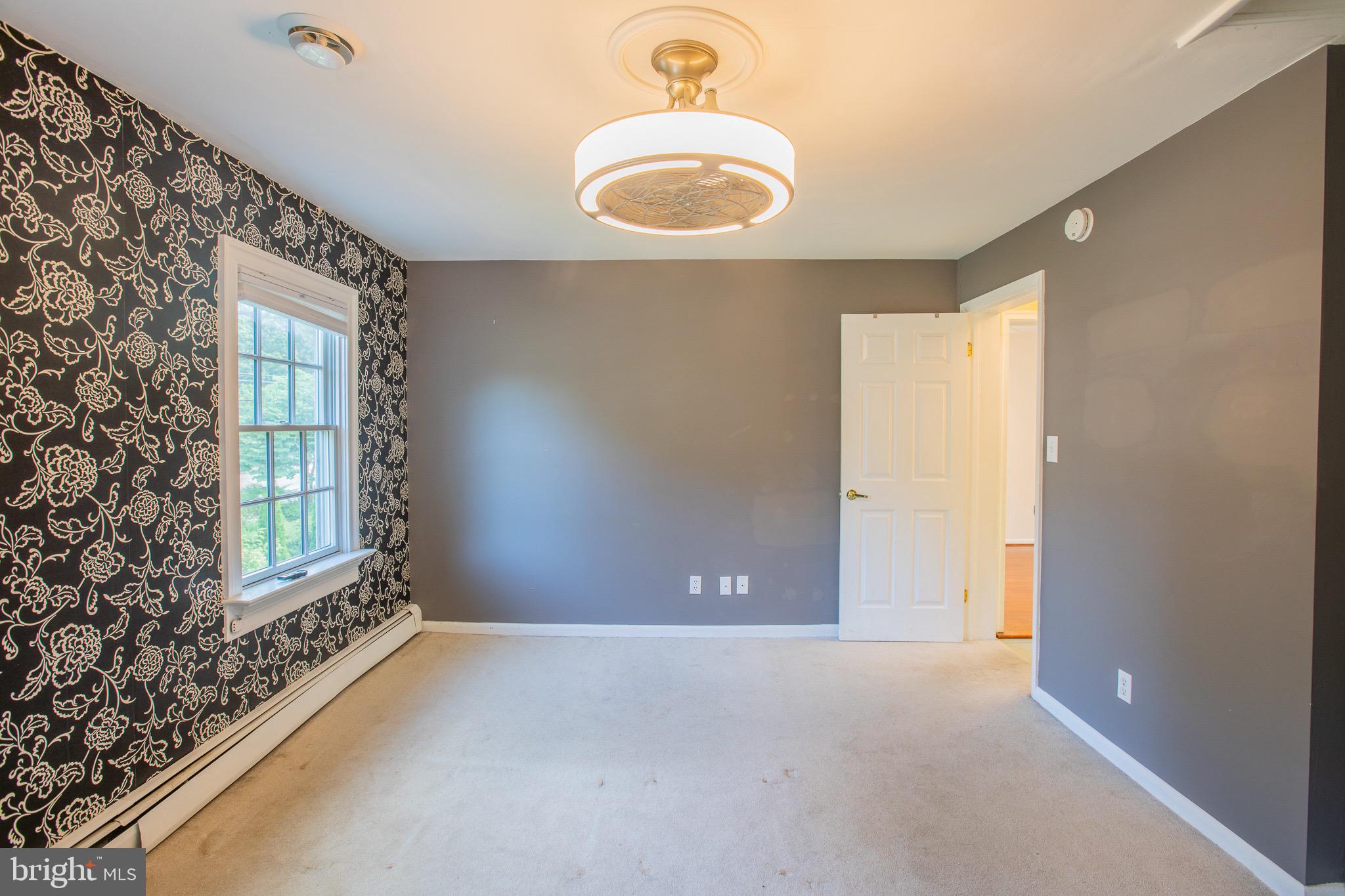 8875 Baltimore Street Savage, MD 20763 - Photo 19 of 32 an empty room with windows and closet