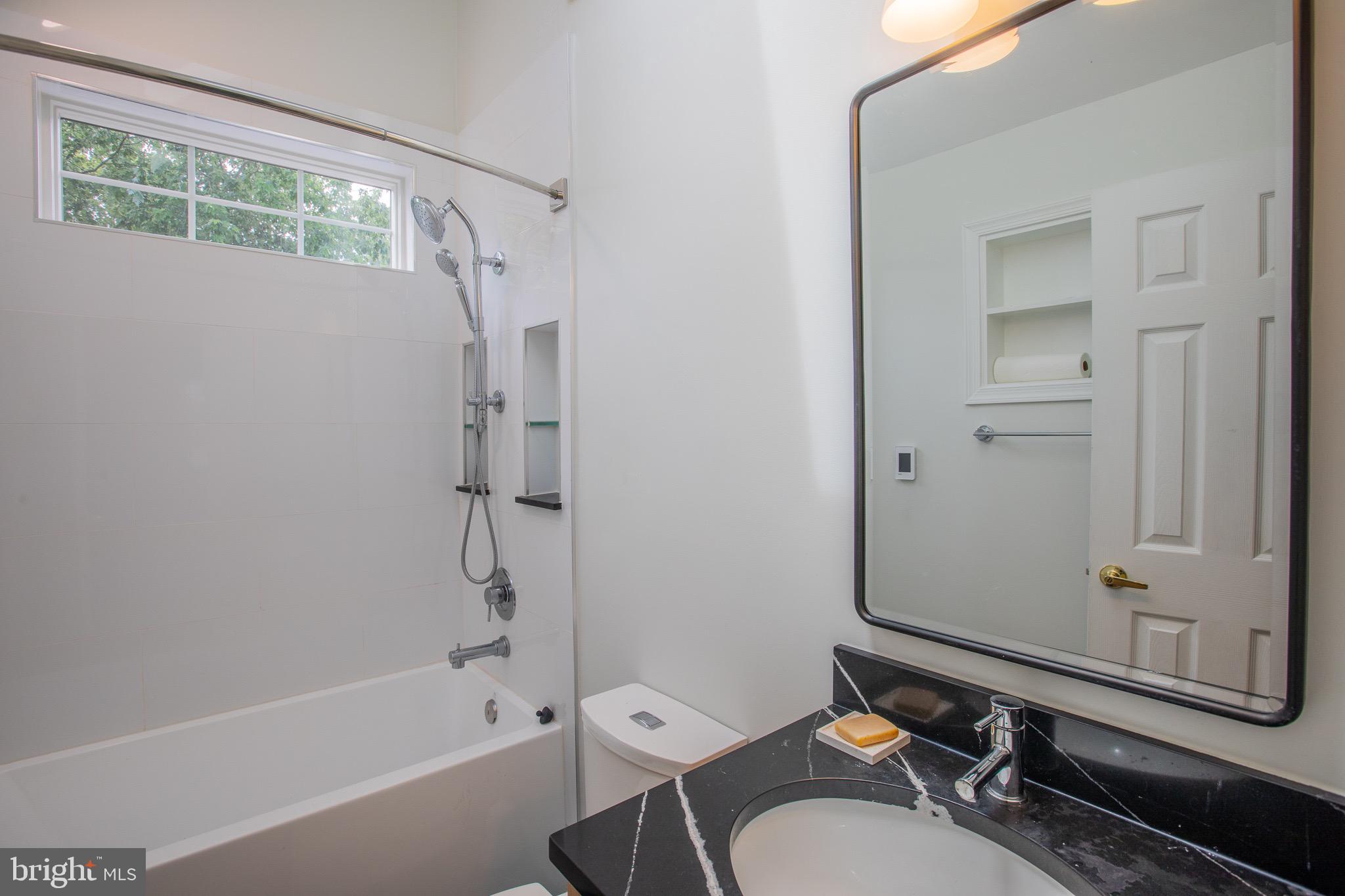 8875 Baltimore Street Savage, MD 20763 - Photo 20 of 32 a bathroom with a granite countertop bathtub shower sink vanity and toilet