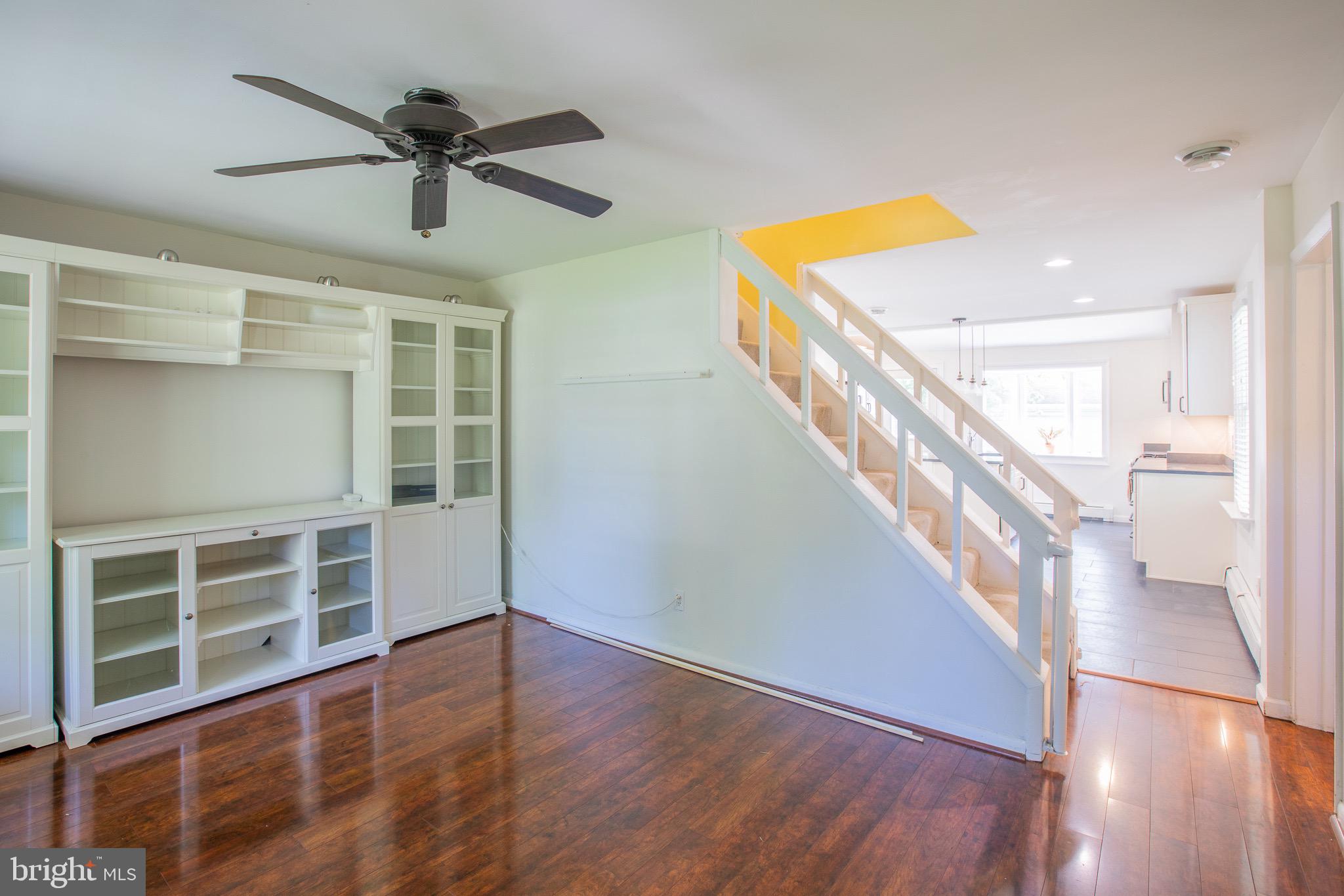 8875 Baltimore Street Savage, MD 20763 - Photo 5 of 32 a view of a hallway with wooden floor and stairs
