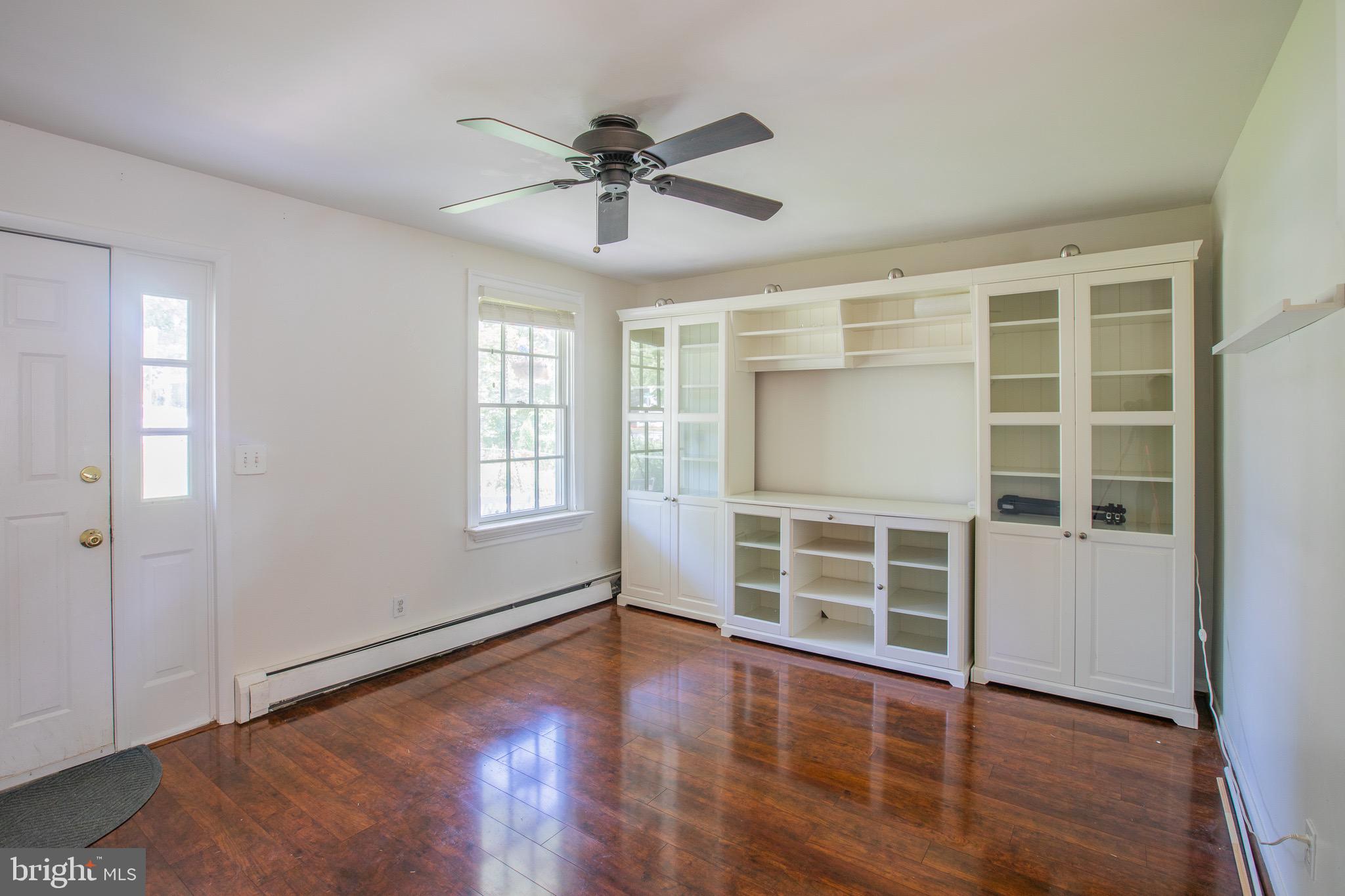 8875 Baltimore Street Savage, MD 20763 - Photo 6 of 32 an empty room with wooden floor closet and windows