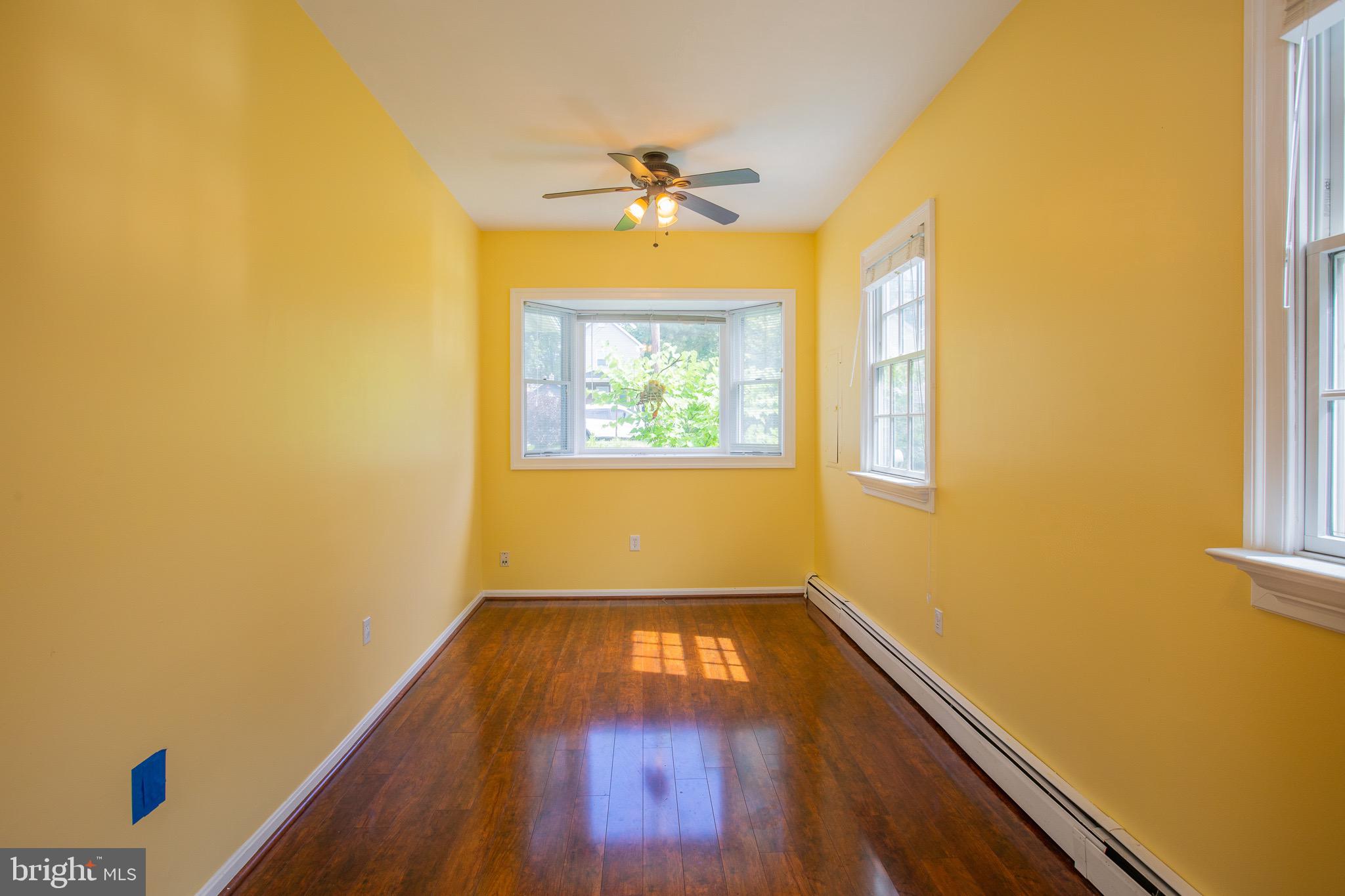 8875 Baltimore Street Savage, MD 20763 - Photo 7 of 32 a view of empty room with a window and wooden floor