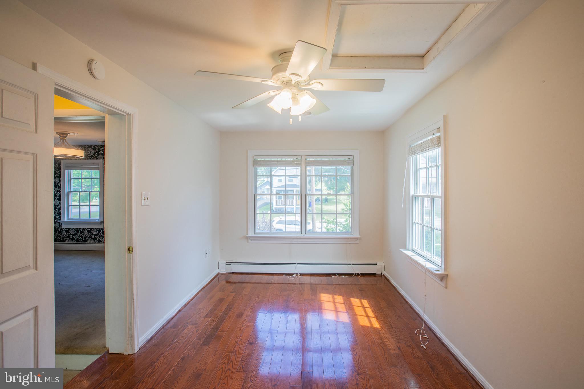8875 Baltimore Street Savage, MD 20763 - Photo 10 of 32 wooden floor in an empty room with a window