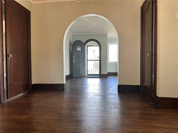 a view of a room with wooden floor closet and windows