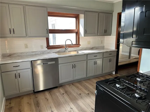 a view of a kitchen sink window and an outdoor space