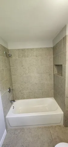 a bathroom with a bathtub and a shower