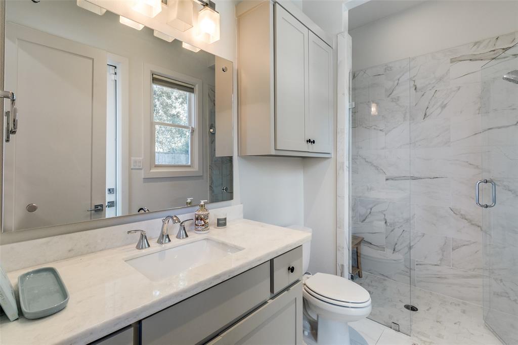 6615 Northwood Road Dallas, TX 75225 - Photo 13 of 30 a bathroom with a sink toilet vanity and shower