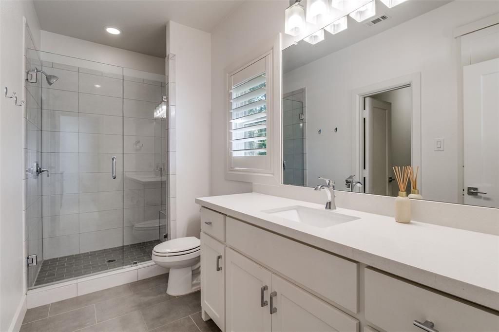 6615 Northwood Road Dallas, TX 75225 - Photo 20 of 30 a bathroom with a sink a toilet and shower