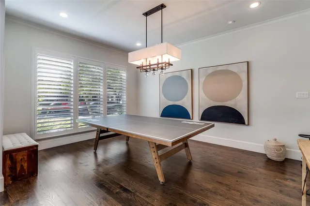 a room with table chairs and wooden floor
