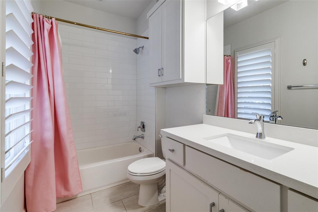 6615 Northwood Road Dallas, TX 75225 - Photo 22 of 30 a bathroom with a sink a toilet and a bathtub