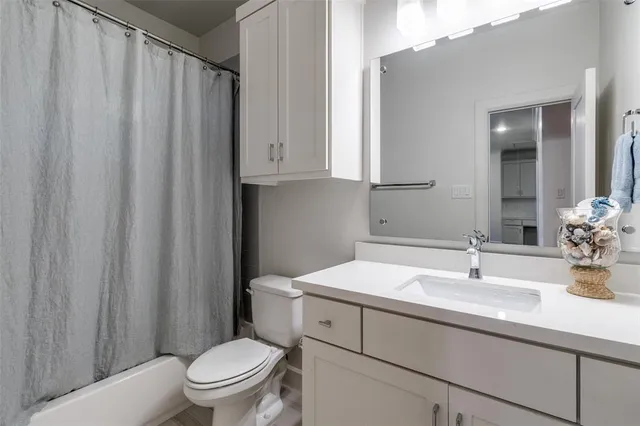 a bathroom with a toilet a sink and a mirror