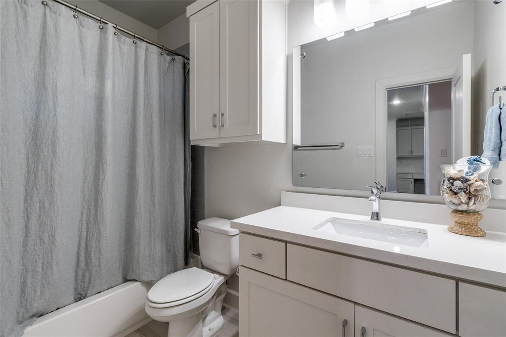 6615 Northwood Road Dallas, TX 75225 - Photo 25 of 30 a bathroom with a toilet a sink and a mirror