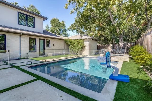 a view of house with swimming pool outdoor seating