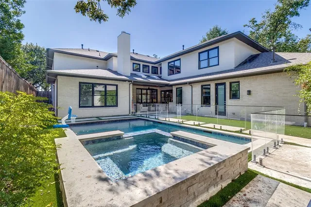 a view of a house with pool and chairs