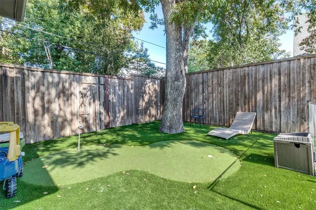 a view of a backyard with a small cabin and a chair