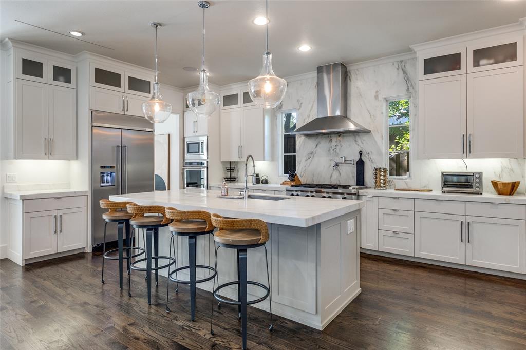 6615 Northwood Road Dallas, TX 75225 - Photo 8 of 30 a kitchen with stainless steel appliances granite countertop a sink and a refrigerator