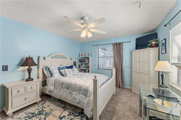 a bedroom with a bed and a dresser in it