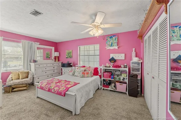 a bedroom with a bed and a couch