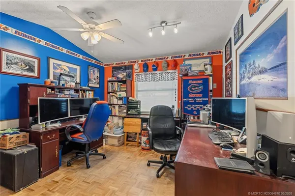 a work room with furniture and a flat screen tv