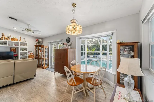 a living room with furniture a window and a chandelier