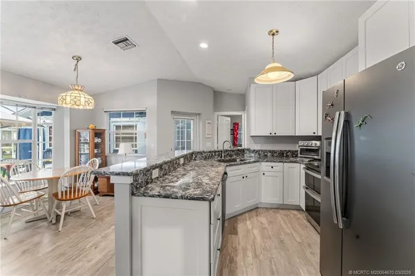 a kitchen with center island and stainless steel appliances