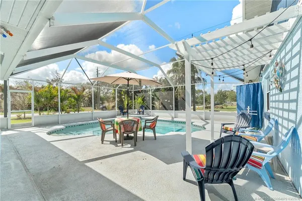 a view of a patio with a table chairs and backyard