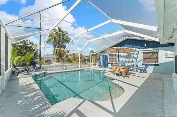 a view of a house with backyard porch and sitting area