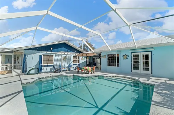 a living room with furniture a flat screen tv and a large window