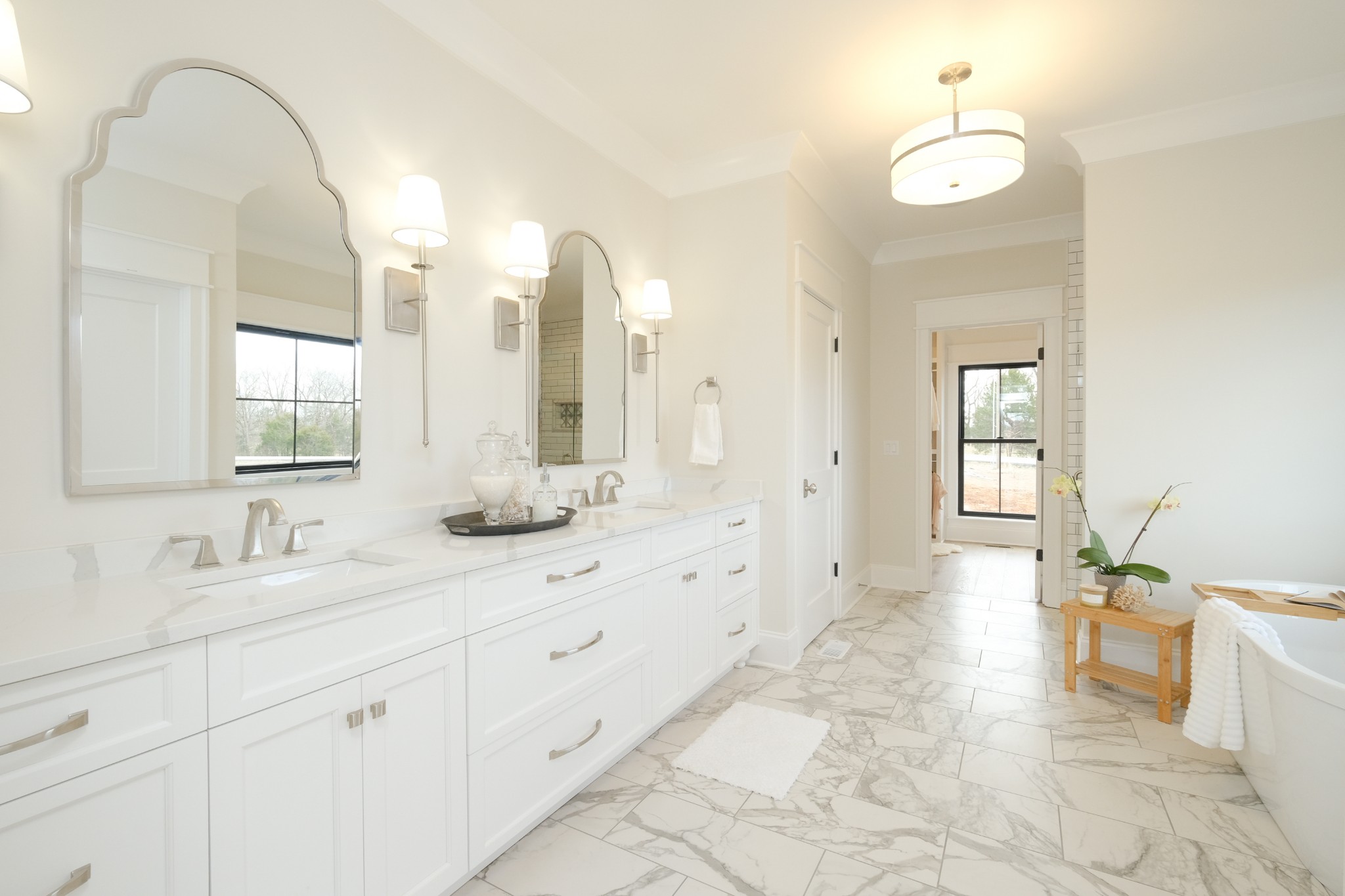 5740 Browns Mill Road Lascassas, TN 37085 - Photo 21 of 44 a spacious bathroom with a double vanity sink a mirror a bathtub and