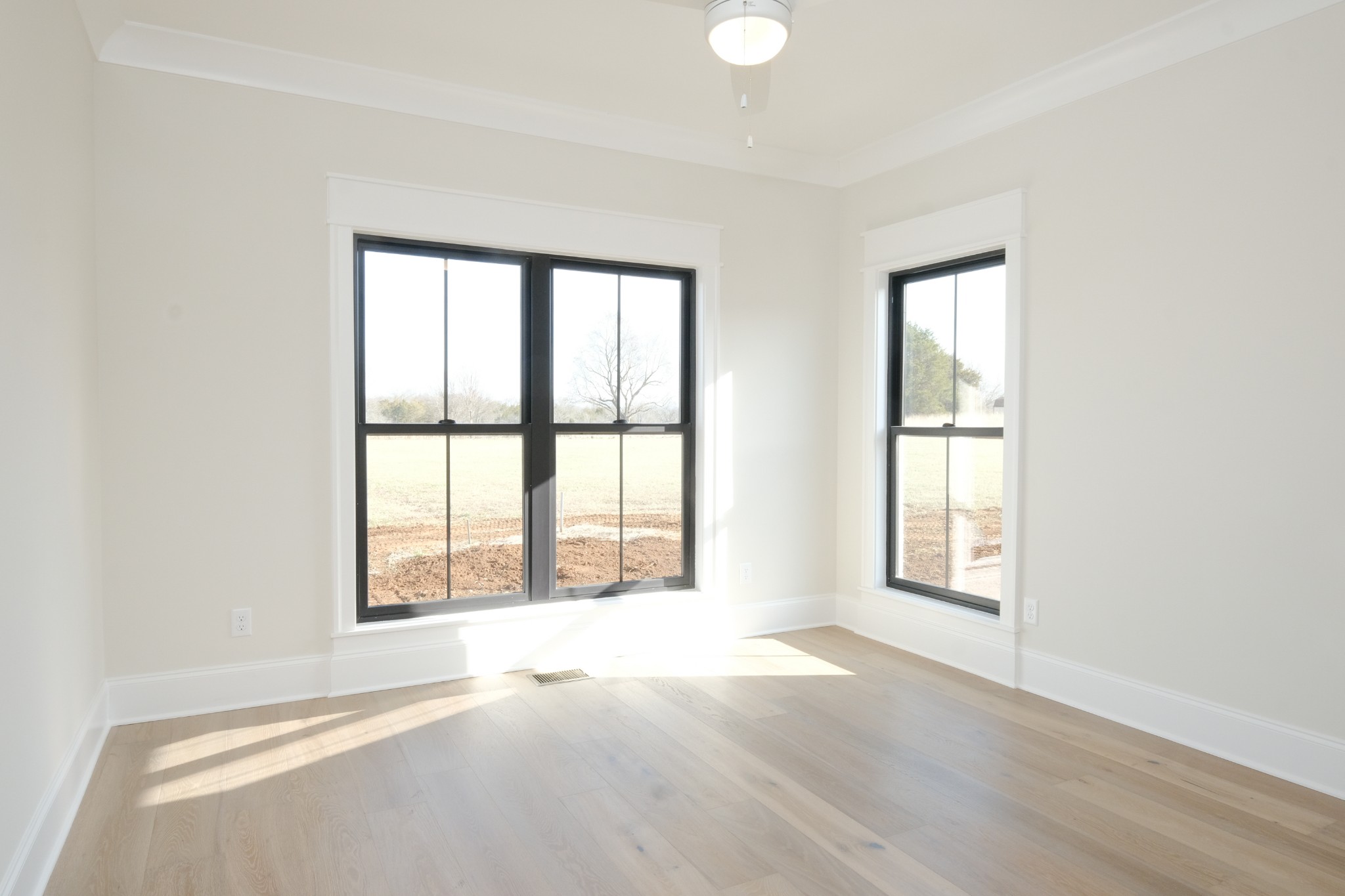 5740 Browns Mill Road Lascassas, TN 37085 - Photo 29 of 44 an empty room with wooden floor and windows