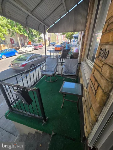 a view of yard from deck with patio